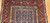 Late 19th Century Antique Kurdish gallery-size rug. Hand-woven. Paisley pattern. Blue background. Predominantly rust-colored border. Ideal for a hallway or as a wide runner.
