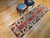 Vintage Turkish Oushak runner with terracotta red field, geometric arrow motifs, and colorful border in yellow, green, blue, pink, and brown,  @thepersianknot  , SKU 1575