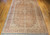 Early 1900s vintage Persian Tabriz rug. Handwoven with a pale apricot background and delicate floral pattern. Small central medallion with soft tones of blue, green, and burgundy. Ivory and green corner spandrels. Pale burgundy and green borders. Fine weave and short pile.