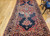 Antique Persian Farahan gallery rug with terracotta medallions on navy blue field and geometric border, late 19th century handwoven rug. The Persian Knot Gallery, SKU 1005