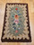 Early American hand-hooked floral rug from New England in rich vintage colors with a brown border, suitable as decorative wall art, The Persian Knot Gallery, SKU: 1451