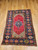 Late 1800s Turkish Anatolian rug with navy blue medallion, red background, tan field, and dark blue geometric border, The Persian Knot Gallery, SKU: 1591