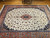 Vintage Persian Tabriz rug with ivory field, terracotta border, and floral medallion, circa 1970s