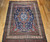 Late 19th Century Antique Persian Kurdish room size rug. Hand-woven. Oversized elongated diamond medallion pattern. Abrash blue color field with streaks of light blue. Medallions in rust, blue, and cream with vines and flowers. Cream-colored main border with geometric design. Colors: navy, French blue, green, yellow, red.