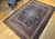 Late 19th Century Antique Persian Kurdish room size rug. Hand-woven. Oversized elongated diamond medallion pattern. Abrash blue color field with streaks of light blue. Medallions in rust, blue, and cream with vines and flowers. Cream-colored main border with geometric design. Colors: navy, French blue, green, yellow, red.