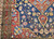 Late 19th Century Antique Persian Kurdish room size rug. Hand-woven. Oversized elongated diamond medallion pattern. Abrash blue color field with streaks of light blue. Medallions in rust, blue, and cream with vines and flowers. Cream-colored main border with geometric design. Colors: navy, French blue, green, yellow, red.
