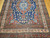 Late 19th Century Antique Persian Kurdish room size rug. Hand-woven. Oversized elongated diamond medallion pattern. Abrash blue color field with streaks of light blue. Medallions in rust, blue, and cream with vines and flowers. Cream-colored main border with geometric design. Colors: navy, French blue, green, yellow, red.