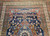 Late 19th Century Antique Persian Kurdish room size rug. Hand-woven. Oversized elongated diamond medallion pattern. Abrash blue color field with streaks of light blue. Medallions in rust, blue, and cream with vines and flowers. Cream-colored main border with geometric design. Colors: navy, French blue, green, yellow, red.