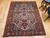 Late 19th Century Antique Persian Bakhtiari Bibibaft area rug. Hand-woven. Over 150 years old. Rare near-square size. Vase pattern (Garden of Paradise) with birds on branches. Pale yellow field. Red border. French blue corners. Extremely tight weave (Bibi