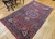 Vintage Persian Bidjar rug with floral medallion and rose bouquet motifs in red, blue, pink, and ivory, early 20th-century handwoven Persian area rug.