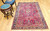 Antique Persian Sarouk rug with floral vase design, white medallion, and navy blue border, The Persian Knot Gallery, SKU 1032