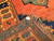 Vintage Kurdish tribal area rug. Hand-woven. Central green medallion on a rich red field. Saffron-colored border with designs in red, green, and blue. Final outer border in green. Small size.