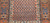 Late 19th Century Antique Kurdish rug. Hand-woven. Paisley pattern variation. Dark brick red background. Rust-colored border with a large design. Narrow cream inner and outer borders.