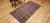 Late 19th Century Antique Kurdish rug. Hand-woven. Paisley pattern variation. Dark brick red background. Rust-colored border with a large design. Narrow cream inner and outer borders.