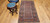 Late 19th Century Antique Kurdish rug. Hand-woven. Paisley pattern variation. Dark brick red background. Rust-colored border with a large design. Narrow cream inner and outer borders.