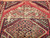 Antique near-square Turkish Village rug with geometric medallion design in terracotta, ivory, turquoise, and green on natural wool.