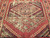 Antique near-square Turkish Village rug with geometric medallion design in terracotta, ivory, turquoise, and green on natural wool.