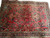 Antique Persian Sarouk rug with floral design on burgundy field and ivory, navy, and green accents, The Persian Knot Gallery, SKU 1034