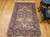 Vintage Persian Kerman Lavar rug with rare silk highlights. Ivory ground with multicolor floral motifs in pink, blue, green & yellow.