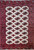 Vintage Turkmen Bokhara area rug with rare ivory field and all-over red and midnight blue medallion pattern, framed by a red geometric border in black and cream, The Persian Knot Gallery, SKU: 1664