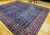 Early 20th Century Vintage Oversize Persian Mahal Sultanabad carpet. Hand-woven. All-over pattern with small medallions and flower heads alternating in columns, connected by curved branches and leaves. Dark navy blue primary field. Dark burgundy border.