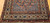 Antique Persian Malayer rug, early 1900s, with geometric design, rust field, French blue spandrels, paisley motifs, and cream border with crab forms.