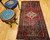 Vintage Persian Hamadan rug in medallion pattern with moss green, red, ivory, and turquoise border featuring geometric and animal motifs.