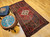 Vintage Persian Hamadan rug in medallion pattern with moss green, red, ivory, and turquoise border featuring geometric and animal motifs.