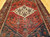 Vintage Persian Hamadan rug in medallion pattern with moss green, red, ivory, and turquoise border featuring geometric and animal motifs.