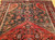 Vintage Persian Hamadan rug in medallion pattern with moss green, red, ivory, and turquoise border featuring geometric and animal motifs.