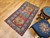 Handwoven early 20th century Kazak rug featuring bold royal blue and yellow medallions on rich red background, The Persian Knot Gallery, SKU 1787