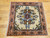 Vintage square Persian Bakhtiari rug with central floral medallion on ivory background in red, blue, green, and brown tones
