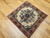 Vintage square Persian Bakhtiari rug with central floral medallion on ivory background in red, blue, green, and brown tones