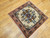 Vintage square Persian Bakhtiari rug with central floral medallion on ivory background in red, blue, green, and brown tones