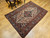 Antique Persian Malayer village rug, late 19th century, pale yellow diamond field with elongated navy medallion and intricate vegetable dye motifs.