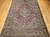 Late 19th Century Antique Persian Kerman Lavar area rug. Hand-woven. 16th-century classic design. Antique red field. Central medallion in French blue and pale pink. Corner spandrels in pale yellow and French blue. Scrolling lines, leaves, and flowers throughout. Pale yellow primary border. Turquoise blue secondary borders. Weaver's signature.