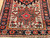 Vintage Persian Heriz Karajeh rug with three medallions in green and red on a cream field, framed by a navy border, hand-knotted circa 1900s.