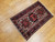 Vintage Persian Heriz Karajeh rug with three medallions in green and red on a cream field, framed by a navy border, hand-knotted circa 1900s.