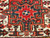 Vintage Persian Heriz Karajeh rug with three medallions in green and red on a cream field, framed by a navy border, hand-knotted circa 1900s.