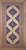 Mid-20th Century Vintage Persian Malayer gallery or corridor size rug. Handwoven. Open-field design on camel hair background. Three axial medallions in deep navy with geometric motifs in baby blue, pink, French blue. Cream field with paisley motif. Corner