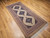 Mid-20th Century Vintage Persian Malayer gallery or corridor size rug. Handwoven. Open-field design on camel hair background. Three axial medallions in deep navy with geometric motifs in baby blue, pink, French blue. Cream field with paisley motif. Corner