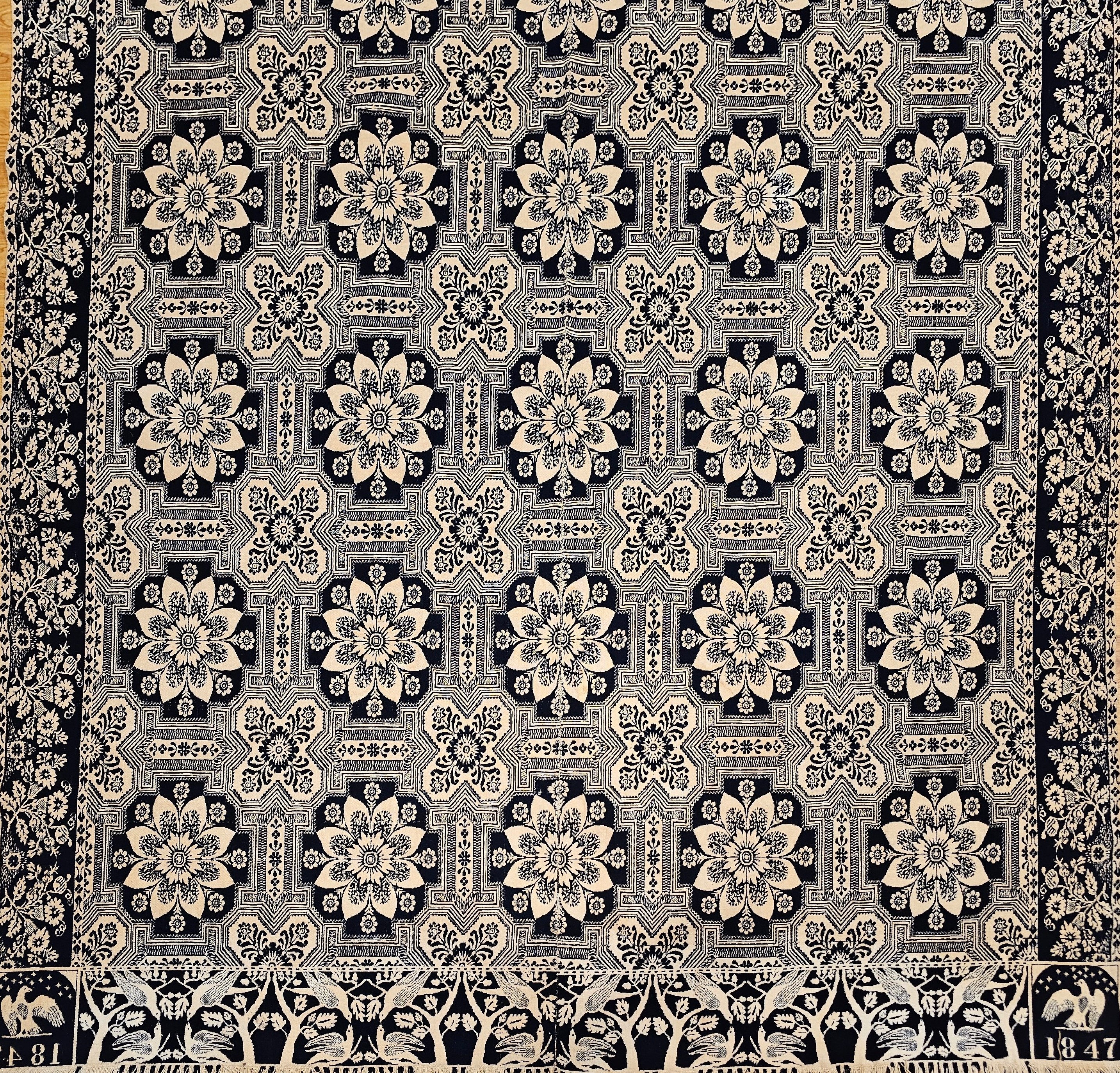 Antique 1847 blue and white Jacquard coverlet with eagle, stars, trees, and birds motifs. A fine example of patriotic American textile art from the 1800s.
