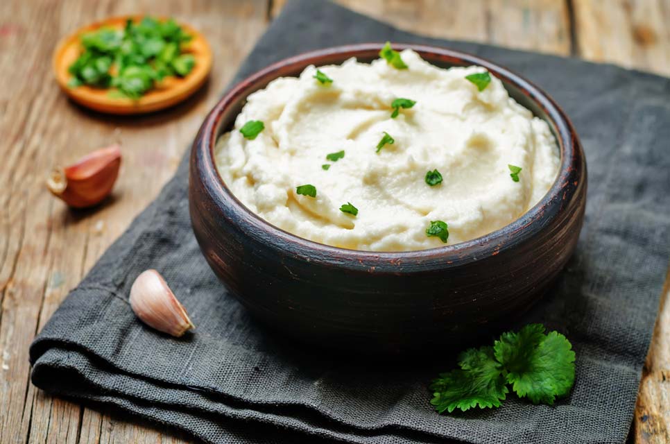 Keep your mashed potatoes low carb with cauliflower. Learn how to make cauliflower mashers with rich goat cheese.
