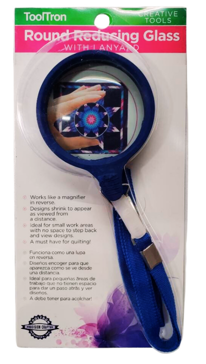 Works like a magnifier in reverse.  Designs shrink to appear as viewed from a distance.  Ideal for small work with no space to step back and view designs.  A must have for quilting.