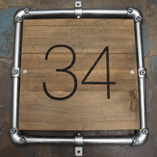 Wooden distressed engraved sign with galvanised frame surround for industrial-look sign