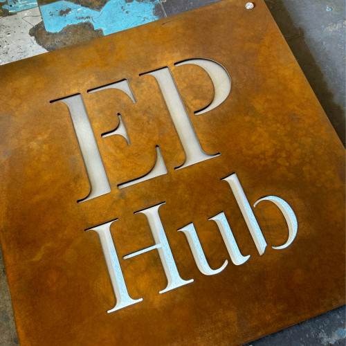 XL Corten steel sign with stainless steel backing plate on stainless steel stand off fixings 