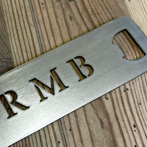 Stainless steel golf bag tag with integrated bottle opener