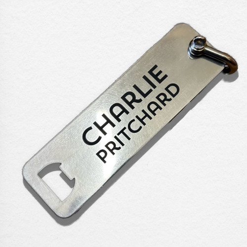 Stainless steel golf bag tag with integrated bottle opener
