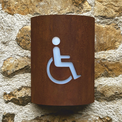 Corten steel curved light with disabled toilet symbol