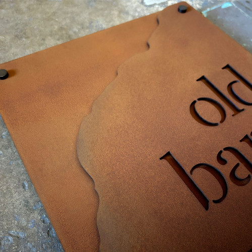 Close up of the cut away edge double layer Corten house name sign